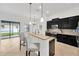 Modern kitchen with black cabinets, stainless steel appliances, breakfast bar at 11926 Cinnamon Fern Dr, Riverview, FL 33579