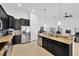 Open kitchen with dark cabinets, granite countertops, and stainless steel appliances at 11926 Cinnamon Fern Dr, Riverview, FL 33579