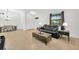 Bright living room features a comfortable leather sofa, stylish coffee table, and neutral decor at 11926 Cinnamon Fern Dr, Riverview, FL 33579