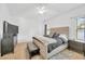 Spacious bedroom with plush carpet, a king-size bed, and windows at 11926 Cinnamon Fern Dr, Riverview, FL 33579