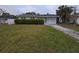 Ranch style home with a large yard and driveway at 121 Pershing Ne St, St Petersburg, FL 33702