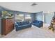 Living room with tiled floors, blue sofas, and a Christmas tree at 1323 W Redbud St, Plant City, FL 33563