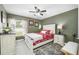 Spacious bedroom with a queen bed and ceiling fan at 14816 Dartmoor Ln, Tampa, FL 33624