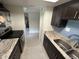 Modern kitchen with granite countertops and stainless steel appliances at 1575 Greenlea Dr # 7, Clearwater, FL 33755