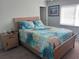 Bedroom with a wooden bed frame and starfish bedding at 1616 70Th N St # 1616, St Petersburg, FL 33710