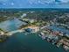 Expansive aerial view of a waterfront condo building, surrounded by lush greenery and waterways at 1860 N Fort Harrison Ave # 104, Clearwater, FL 33755