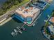 Aerial view of a waterfront building with boat docks, a community pool, and access to main road at 1860 N Fort Harrison Ave # 104, Clearwater, FL 33755