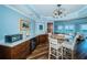 Wet bar and nook features a wine fridge, cabinets, and a gorgeous chandelier at 1860 N Fort Harrison Ave # 104, Clearwater, FL 33755