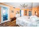 Comfortable bedroom featuring a ceiling fan, access to a porch, and a glimpse of an en-suite bath at 1860 N Fort Harrison Ave # 104, Clearwater, FL 33755