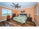 Cozy bedroom with hardwood floors, tropical bedding, and a view of the water at 1860 N Fort Harrison Ave # 104, Clearwater, FL 33755