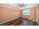 Serene bedroom with wood flooring and a window offering beautiful water views at 1860 N Fort Harrison Ave # 104, Clearwater, FL 33755