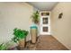 Inviting entrance with colorful potted plants and brick flooring leading to a bright doorway at 1860 N Fort Harrison Ave # 104, Clearwater, FL 33755