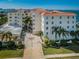 Gorgeous waterfront building with a circular entrance, mature palms and meticulously maintained lawns at 1860 N Fort Harrison Ave # 104, Clearwater, FL 33755