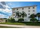Attractive condo building with landscaped grounds, lush green lawn, and well-kept exterior facade at 1860 N Fort Harrison Ave # 104, Clearwater, FL 33755