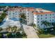 Beautiful waterfront building featuring lush landscaping and a circular driveway leading to the entrance at 1860 N Fort Harrison Ave # 104, Clearwater, FL 33755
