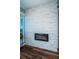 Modern fireplace with white stone facade and wood-look flooring, creating a cozy ambiance at 1860 N Fort Harrison Ave # 104, Clearwater, FL 33755
