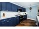 Kitchen features navy cabinets, stainless steel appliances, and quartz countertops at 1860 N Fort Harrison Ave # 104, Clearwater, FL 33755