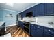 Kitchen with stainless steel appliances, navy cabinets, and wood floors at 1860 N Fort Harrison Ave # 104, Clearwater, FL 33755
