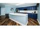 Kitchen with island, navy cabinets, stainless steel appliances, and wood floors at 1860 N Fort Harrison Ave # 104, Clearwater, FL 33755