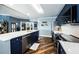 Open kitchen features stainless appliances, quartz counters, and breakfast bar at 1860 N Fort Harrison Ave # 104, Clearwater, FL 33755