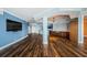 Open floor plan with wood floors, wet bar, and access to kitchen and balconies at 1860 N Fort Harrison Ave # 104, Clearwater, FL 33755