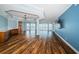 Spacious living room with wood-look floors, a wet bar, and scenic waterfront views from large windows at 1860 N Fort Harrison Ave # 104, Clearwater, FL 33755