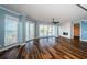 Bright living room with waterfront views, modern ceiling fan, and beautiful wood-look flooring at 1860 N Fort Harrison Ave # 104, Clearwater, FL 33755