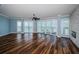 Expansive living room with waterfront views from large windows and modern ceiling fan at 1860 N Fort Harrison Ave # 104, Clearwater, FL 33755