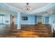 Open living space with wood floors, modern lighting, and access to other rooms at 1860 N Fort Harrison Ave # 104, Clearwater, FL 33755