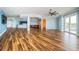 Spacious living area features wood floors, recessed lighting, and balcony access at 1860 N Fort Harrison Ave # 104, Clearwater, FL 33755