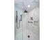 Shower with white tile, a shower head, a hand shower, and two built in shelves at 1860 N Fort Harrison Ave # 104, Clearwater, FL 33755