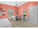 Bedroom with coral walls, bed, desk, and storage at 1932 Brainerd Ct, Lutz, FL 33549