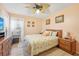 Spacious bedroom with wood furniture and flamingo bedding at 2048 Berry Roberts Dr, Sun City Center, FL 33573