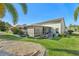 House exterior showcasing a screened patio and manicured lawn at 2048 Berry Roberts Dr, Sun City Center, FL 33573