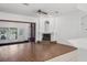 Living room with hardwood floors, fireplace and sunroom access at 211 Arlington E Ave, Oldsmar, FL 34677