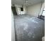 Large empty room with bare subfloor and built-in shelving at 300 Woodette Dr # 303D, Dunedin, FL 34698