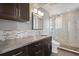 Modern bathroom with dark vanity, concrete counter, and tiled shower at 405 Central Ave # 700, St Petersburg, FL 33701