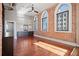 Spacious bedroom with hardwood floors, exposed brick, and large windows at 405 Central Ave # 700, St Petersburg, FL 33701