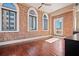 Bright bedroom with hardwood floors, exposed brick, and large windows at 405 Central Ave # 700, St Petersburg, FL 33701
