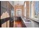 Modern kitchen with dark cabinetry, concrete counters, and exposed brick walls at 405 Central Ave # 700, St Petersburg, FL 33701
