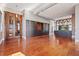 Living room with hardwood floors, exposed brick, and custom cabinetry at 405 Central Ave # 700, St Petersburg, FL 33701