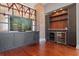 Open living area with hardwood floors, exposed brick, and large windows at 405 Central Ave # 700, St Petersburg, FL 33701