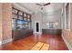 Open living area with hardwood floors, exposed brick, and built-in entertainment center at 405 Central Ave # 700, St Petersburg, FL 33701