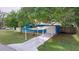 Blue house with carport and landscaped yard at 5401 13Th S Ave, Gulfport, FL 33707