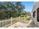 Relaxing patio with white picket fence and lounge chairs at 601 Canal Way, Oldsmar, FL 34677