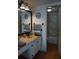 Bathroom vanity with sink, mirror, and open door to tub/shower at 6218 Palma Del Mar S Blvd # 503, St Petersburg, FL 33715