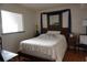 Bedroom with wooden bedframe, mirror over headboard, and tiled floor at 6218 Palma Del Mar S Blvd # 503, St Petersburg, FL 33715