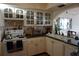 Kitchen with white cabinets, dark countertops, and glass-front upper cabinets at 6218 Palma Del Mar S Blvd # 503, St Petersburg, FL 33715