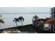 View of the water with palm trees, buildings, and a boat at 6218 Palma Del Mar S Blvd # 503, St Petersburg, FL 33715