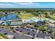 Aerial view of community amenities including clubhouse, pool, and tennis courts at 6325 Stone River Rd, Bradenton, FL 34203